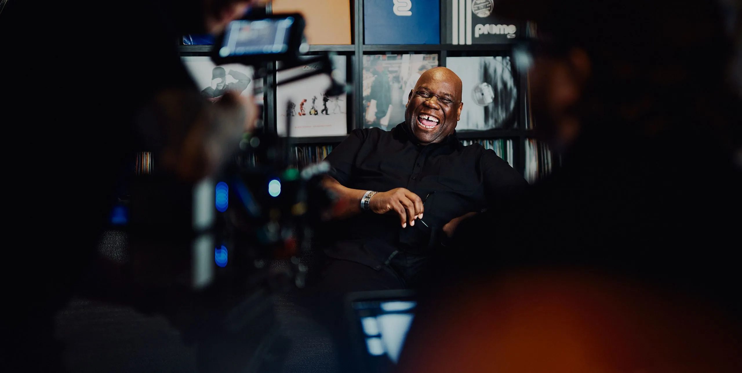 Carl Cox laughing on set with the camera crew in the foreground, filming the Universe launch video